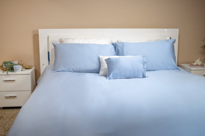 100% cotton duvet cover in a clean, crisp weave styled on a bed with pillows