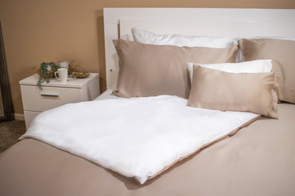 Neutral beige and cream bedding set styled in a calm, minimalist bedroom